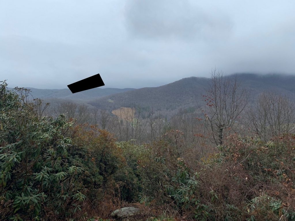Football field sized rectangle, black, near Boone N.C. that disappeared at a high rate of speed.