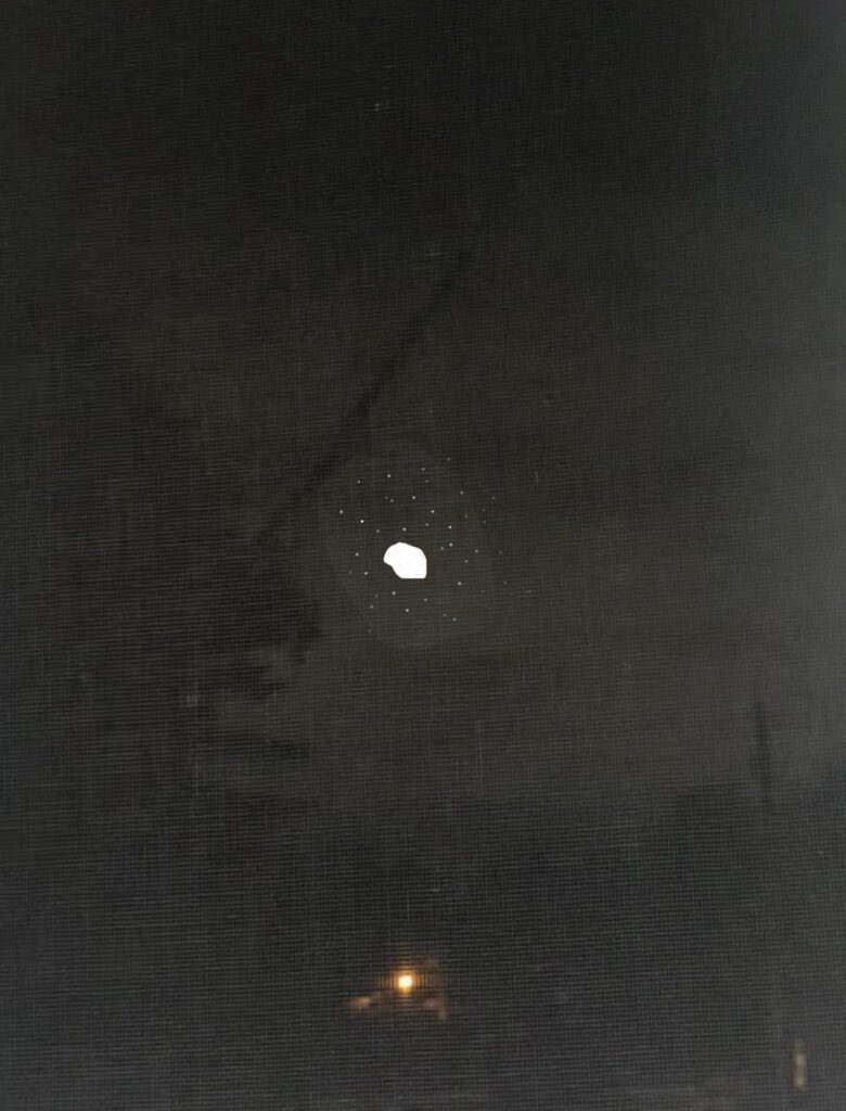 Bright light orb un perfect odd circle thing in the sky surrounded with stars